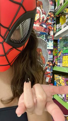 a person wearing a spider man mask in a store