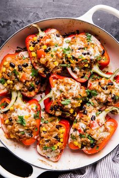 stuffed bell peppers in a skillet on a table