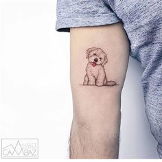 a small dog tattoo on the left inner arm and leg, with a red heart in it's mouth