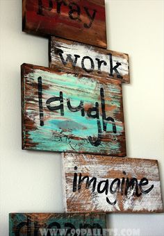 three wooden signs that say work laugh imagine and dream hanging on the wall in front of a white wall