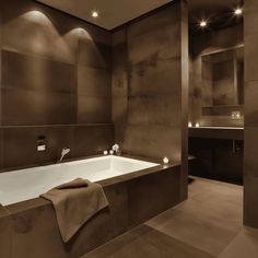 a bathroom with a large bathtub and two sinks