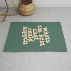 a green rug with the words, i am not going to bed again and there is a basket on the floor next to it