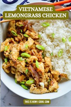 a bowl filled with rice and meat next to chopsticks on a table top