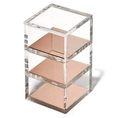 three tiered clear acrylic display case with pink and gold squares on the sides