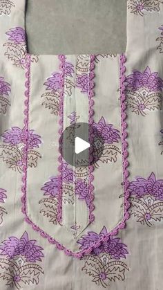 a piece of cloth with purple flowers on it and a video about how to sew