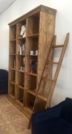 a wooden bookcase with ladder leaning against the wall