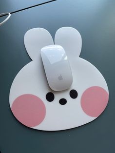 an apple mouse sitting on top of a mouse pad