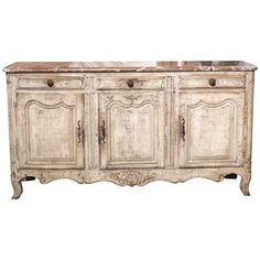 an old white sideboard with marble top and two doors on the bottom, in front of a white background