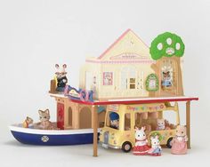 a toy house with animals on it and a boat