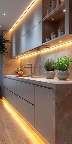 a modern kitchen with wooden floors and white counter tops is lit up by recessed lighting