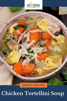 a bowl of chicken tortellini soup with spinach and carrots in it