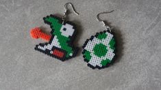 a pair of earrings made to look like an old school video game character holding a carrot