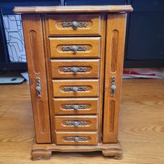 a wooden cabinet with many drawers on top of it