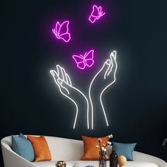 a living room filled with furniture and a neon sign above it that says butterflies on the wall