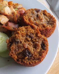 a white plate topped with muffins and fruit