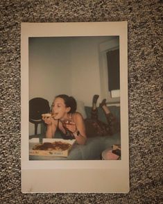 an old photo of a woman eating pizza