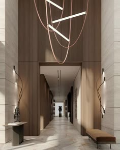 a long hallway with wooden walls and lights hanging from it's ceiling, along with a bench in the middle