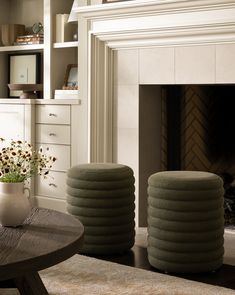 a living room filled with furniture and a fire place in front of a white fireplace