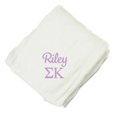 a white towel with the word riley on it and purple letters in front of it