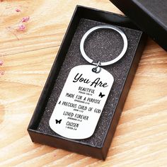 a key chain in a box that says you are beautiful