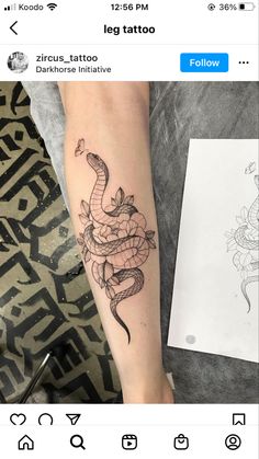 a woman's arm with a tattoo on it and a drawing of a snake