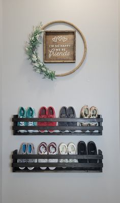 there are many pairs of shoes on the shelves in this room that is decorated with a wreath