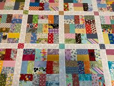 a patchwork quilt with many different colored squares