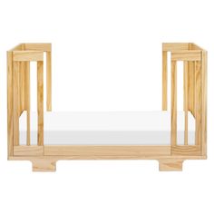 a wooden crib with a white mattress in the bottom and side rails on each end