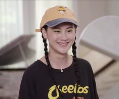 a woman with braids wearing a baseball cap