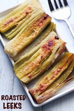 roasted leeks on a plate with a fork