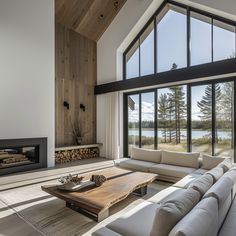 a living room with couches and a fire place in the corner near a large window