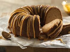 a bundt cake with caramel drizzled on top and slices cut out