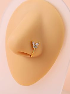 a gold ring with two small diamonds on it's side, in the shape of a flower