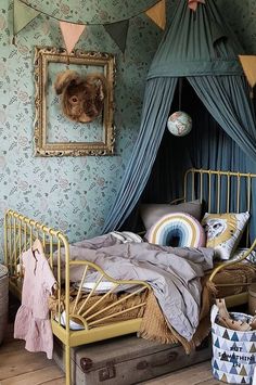 a bedroom with a canopy bed and lots of decorations on the wall above it,