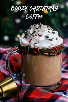 a hot chocolate drink with whipped cream and sprinkles on a plaid tablecloth