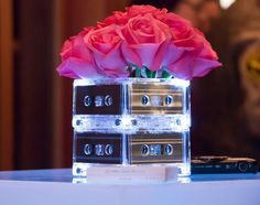 three cassettes are stacked on top of each other with roses in them