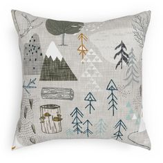 a pillow with trees and mountains on it