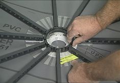 a man is working on an umbrella with measuring tape around the spokes and center