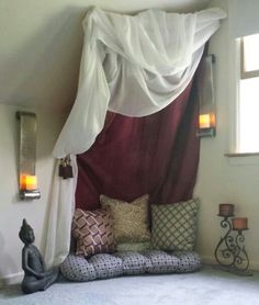 a canopy bed with pillows on top of it