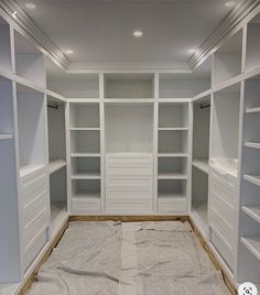 an empty walk - in closet with white shelving and carpeted flooring is shown