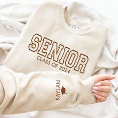 a person holding onto a shirt that says senior class of 2012