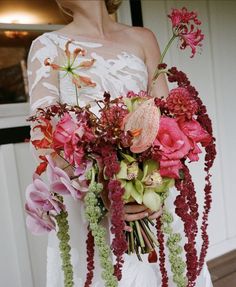 a woman holding a bouquet of flowers in her hands