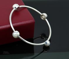 These bangles are amazing pearls and it available in all sizes. best handmade 925 Sterling silver awesome white pearl bangle bracelet, excellent gifting tribal ethnic bangle jewellery for gifting from India. Metal-925 Sterling Silver. Item type- Bangle/Bracelet. Width-2.5mm (stone part width-10mm) Size-2-2 to 2-10(select your size.) Weight- 15 to 18 Grams. Stamped-925. Finish-Oxidized. Quantity-Single kada. Makes excellent gifting for birthdays, mother's day, wedding, anniversary. Sterling Silver Wedding Bangle, White Pearl Round Bangle, Pearl Bangle As Gift, Sterling Silver Stackable Wedding Bangle, Wedding Sterling Silver Round Pearl Bracelet, Handmade Round White Gold Bangle, Sterling Silver Bangle Pearl Bracelet As Gift, Handmade Sterling Silver Bracelet For Wedding, Handmade Sterling Silver Round Bracelet For Wedding