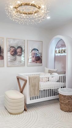 a baby's room is decorated in white and gold with pictures on the wall