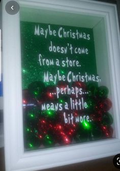 a christmas message in a frame with lights on the bottom and words below it that read maybe christmas doesn't come from a store