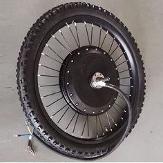 the front wheel of a motorcycle with spokes and hubs attached to it's rear tire