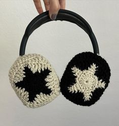 a crocheted black and white bag hanging from a hook