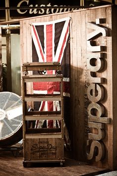 an old wooden crate sitting on top of a table next to a fan and other items