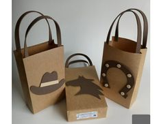 three brown paper bags with cowboy hats on them