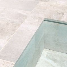 a white toilet sitting on top of a tiled floor